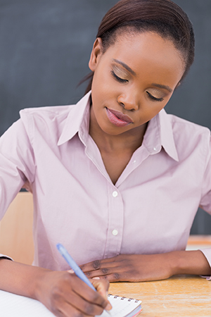 Woman writing in log.